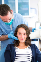 Young attractive dentist doing a radiography of woman teeth
