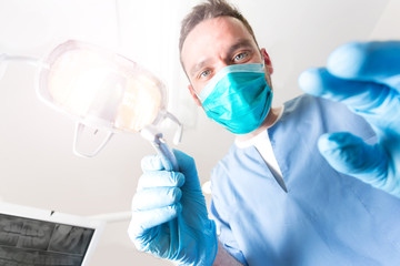 View from patient of a dentist at work