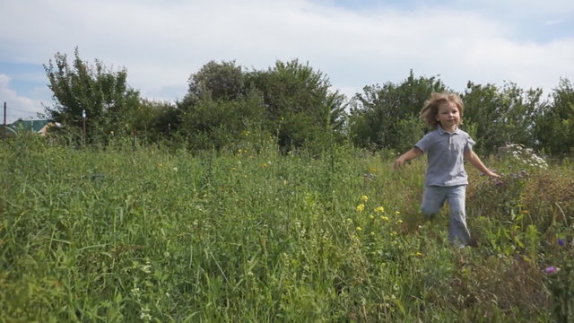 Happy child running through a meadow 
