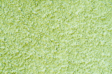 Decorative light green relief plaster on wall closeup
