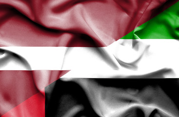 Waving flag of United Arab Emirates and Latvia
