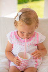 Little Toddler Girl Drinking Lemon Water