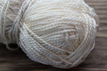White Rope and Textured Wood, Coil of white rope set against highly textured wood.