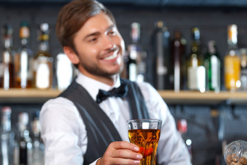 Handsome bartender during work