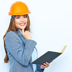 Business woman wearing a building protect helmet, holding busin