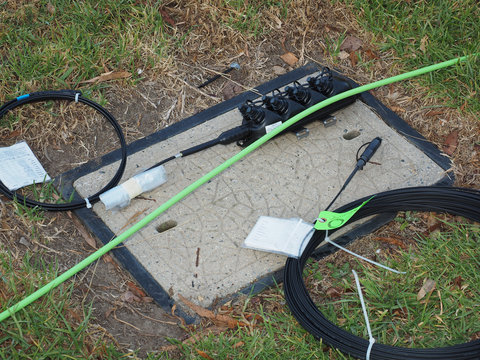 Melbourne, Australia - 2015, April 10: Road side communications pit with cable, 8 port multiport and drop cable used for the installation of the National Broadband Network.