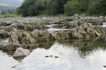 small mountain river flowing over rocks