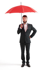 serious businessman under red umbrella