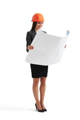 woman in hardhat looking at blueprint