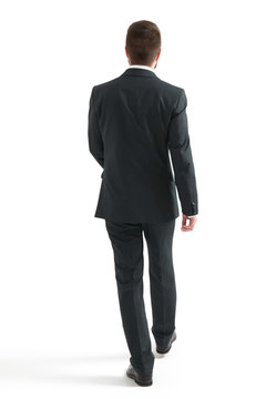 walking businessman in black suit