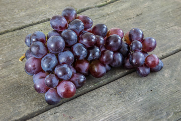 Grapes on a rustic wooden background