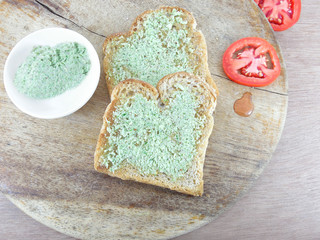 Coconut chutney applied to toasted wheat bread.