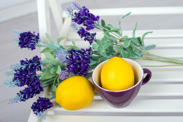 Still life with fresh lemons and lavender on light background