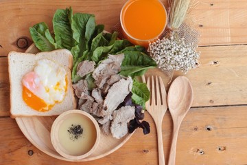 soft-boiled egg on toast with sliced pork tenderloin.