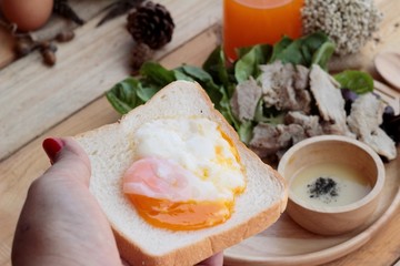 soft-boiled egg on toast with sliced pork tenderloin.
