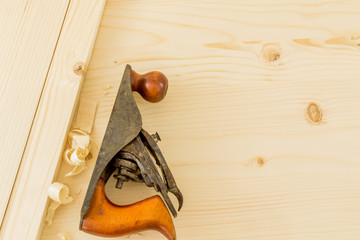 Jointer on a fresh wooden board wood shavings