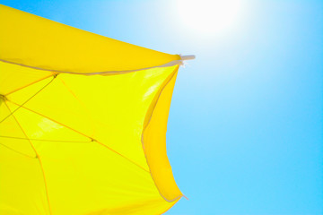 yellow parasol under a shining sun