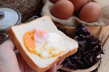soft-boiled egg with bread on wood background.