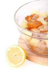 Fototapeta na wymiar Cutted chicken fillet with pineapple pieces in bowl