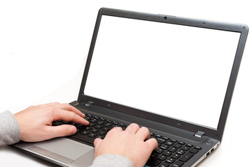 Hands on a laptop computer with blank screen isolated on white background