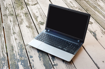 Closeup laptop computer on wooden floor. selective focus image