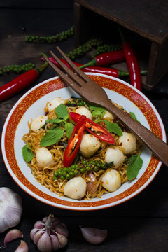 Instant noodle fried with spicy sauce and fish ball
