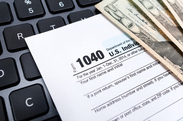 Individual 1040 tax return form on a laptop keyboard