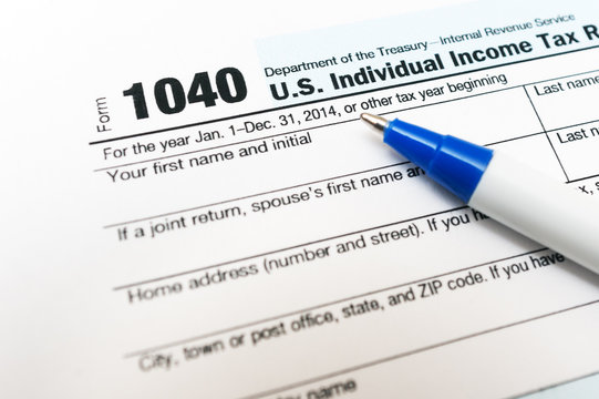 US Individual Tax Return Form 1040 close up and pen