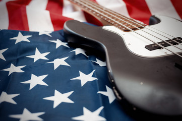 Naklejka premium Vintage Bass guitar body on american flag background. selective focus image with shallow depth of field