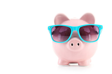 Pink piggy bank with glasses isolated on a white