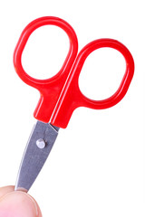 Red scissors in hand