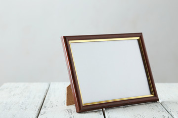 Wooden frame on white wooden background