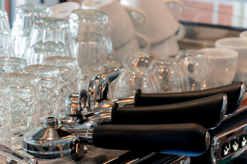 Three portafilter on espresso machine with coffee glasses