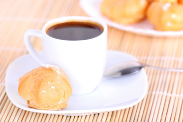 Cup of coffee and cakes on wooden mat
