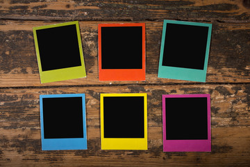 Six color frames on wooden background