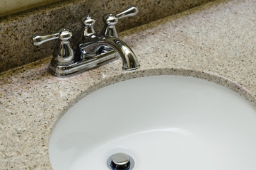 Retro style Chrome Faucet and old sink in bathroom. Selective focus on a tap