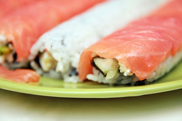 Ready sushi roll on green plate