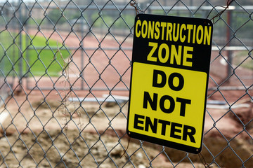 Construction zone sign at a baseball field under renovation 