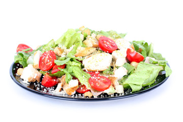 Caesar salad on black plate