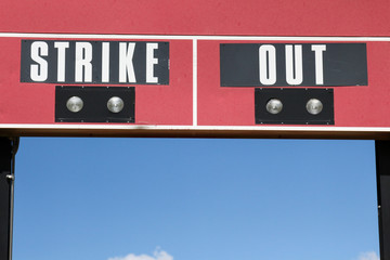 The words strike and out on a baseball scoreboard in New Mexico