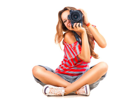 Beauty teenage girl photographer sitting over white background