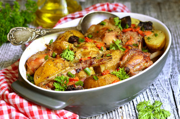 Rabbit baked with young potato in a cream.