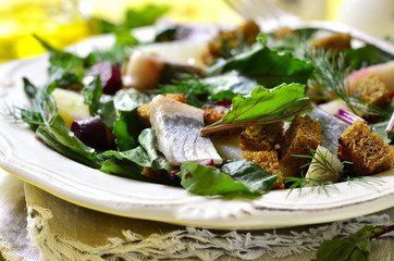 Salad with fresh organic beetroot,herrings and rye croutons.