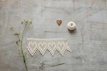 Vintage white crocheted lace on the wooden background