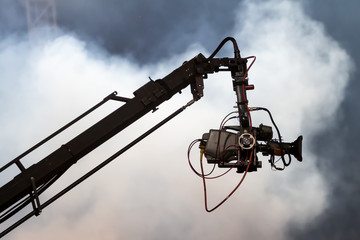 TV camera on a crane on football mach or concert
