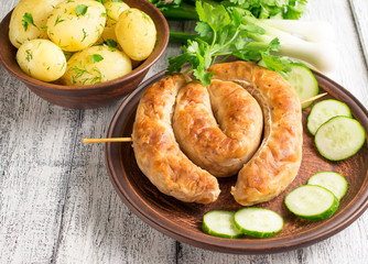 Young boiled potatoes with dill, sausage, cucumber, parsley and