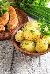 Young boiled potatoes with dill, sausage, parsley and onions