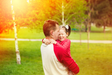 Fototapeta premium Happy daddy with daughter playing in summer sunny day