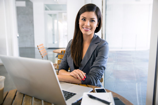 Portrait of attractive Business woman outside the office female professional sitting smiling