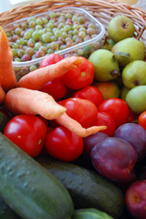 assorted raw organic vegetables and fruits in a basket